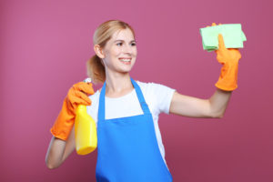Pretty adult woman with napkin and detergent